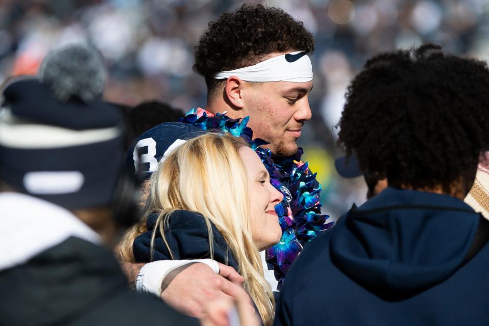 Penn State tight end Theo Johnson hugs his mom, Amy Johnson, during a senior day ceremony before an NCAA football game against Rutgers Saturday, Nov. 18, 2023, in State College, Pa.