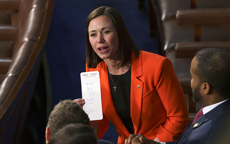 Sen.-elect Katie Britt (R-Ala.) holds a “hall pass” from House Majority Leader Steve Scalise (R-La.) following President Biden’s State of the Union address to a joint session of Congress on Feb. 7. <em>Greg Nash</em>