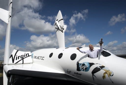 British billionaire Richard Branson in the window of a replica of the spaceship he plans to launch for his new Virgin Galactic space tourism programme, at the Farnborough Air Show in Britain. Branson said Wednesday that he and his family will be the first on board his new Virgin Galactic space tourism programme