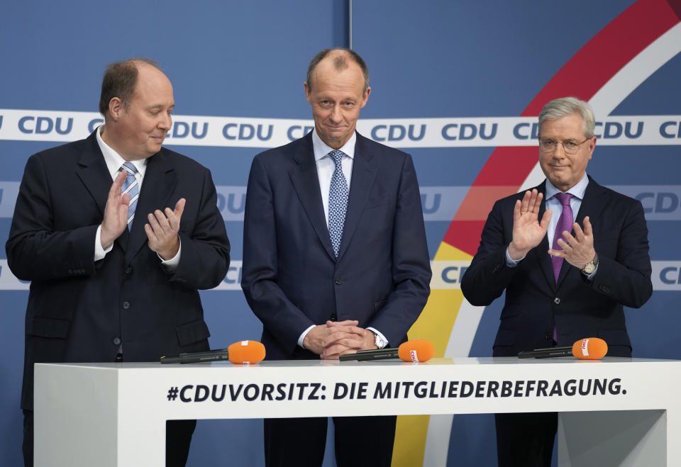 From left, candidate Helge Braun, new elected party chairman Friedrich Merz and candidate Norbert Roettgen, attend a press conference of the German Christian Democratic Party (CDU) at the party's headquarters in Berlin, Germany, Friday, Dec. 17, 2021 to announce the results of a ballot on who will become its new leader. (AP Photo/Michael Sohn)