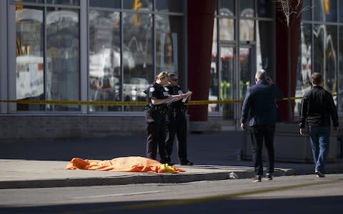 A tarp covers an unidentified body on Yonge St. at Finch Avenue - Credit: Cole Burston/Getty Images