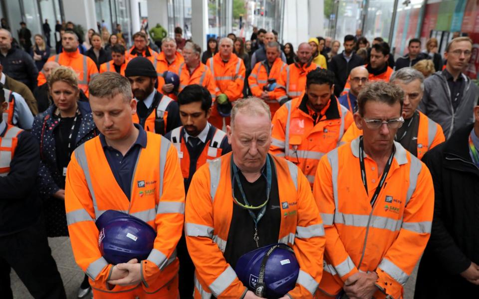 Workers observe a minute's silence for the victims of the attack on London Bridge and Borough Market at London Bridge Station, London - Credit: REUTERS/Marko Djurica
