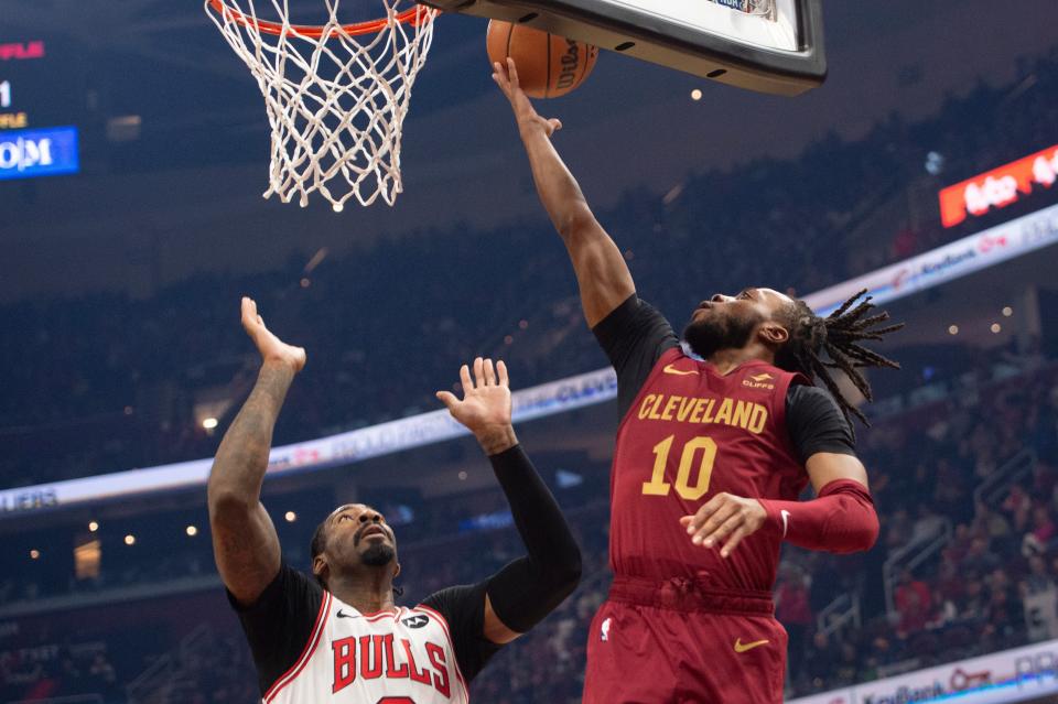 Cleveland Cavaliers' Darius Garland (10) shoots as Chicago Bulls' Andre Drummond defends during the first half of an NBA basketball game in Cleveland, Wednesday, Feb. 14, 2024. (AP Photo/Phil Long)