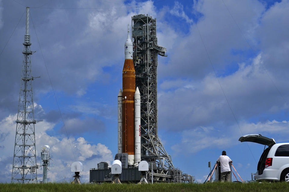 Photographers place remote cameras near the Artemis 1 rocket as she stands on Launch Pad 39-B at the Kennedy Space Center, Friday, Aug. 26, 2022, in Cape Canaveral, Fla. The launch is scheduled for Monday morning Aug. 29. (AP Photo/Brynn Anderson)