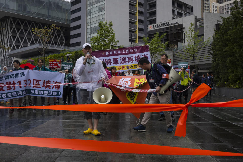 Protesters wearing number tags during a rally in Hong Kong, Sunday, March 26, 2023. Dozens of people on Sunday joined Hong Kong's first authorized demonstration against the government since the lifting of major COVID-19 restrictions under unprecedentedly strict rules, including wearing a numbered badge around their necks. (AP Photo/Louise Delmotte)