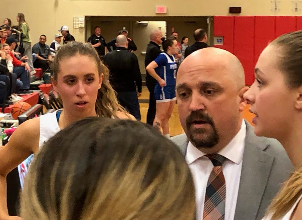 Illini Bluffs head coach Jim Belville huddles with his team during a timeout in the Tigers 47-41 upset of No. 1 Galena in the IHSA Class 1A girls Super-Sectional at Brimfield on Monday, Feb. 26, 2024.