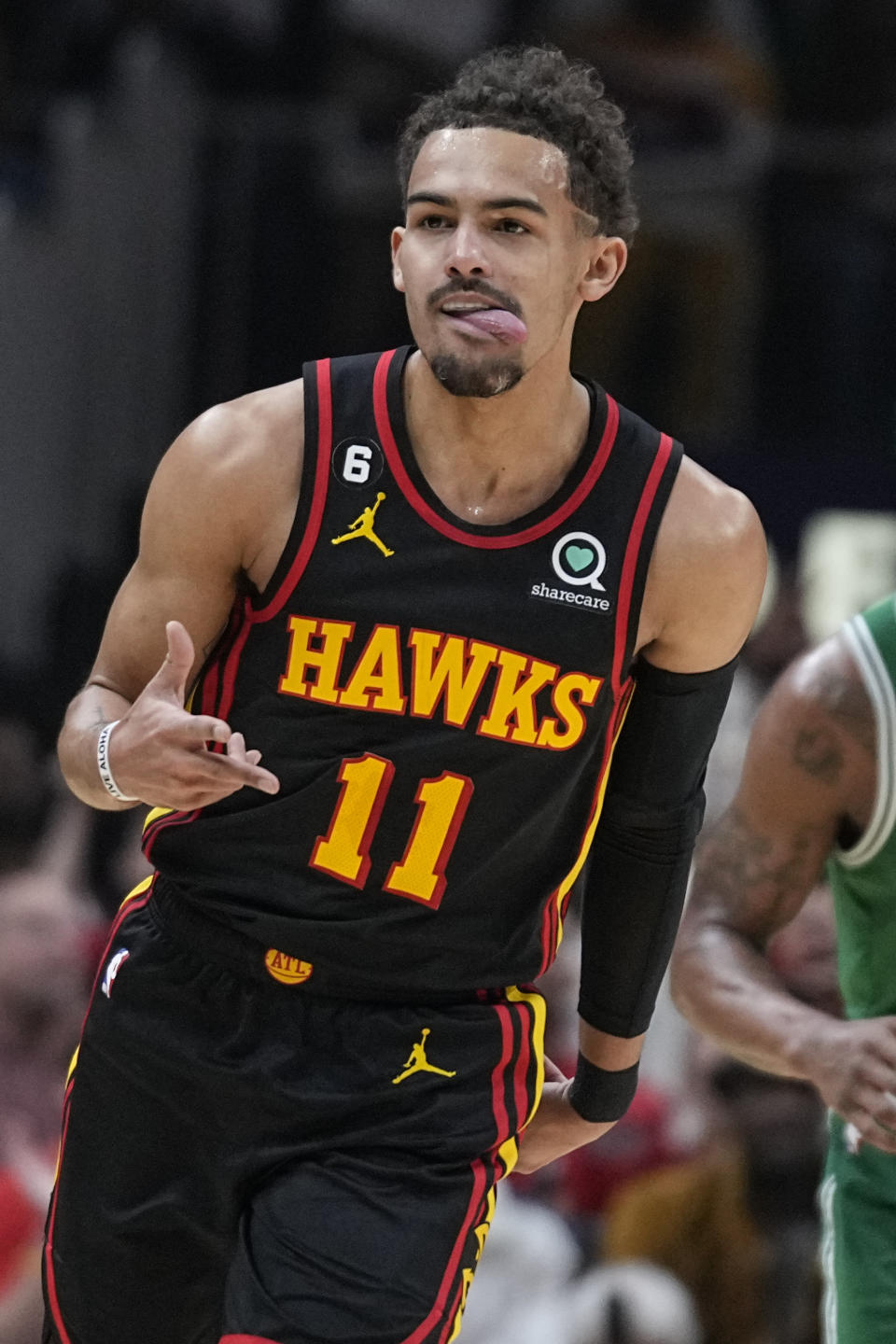 Atlanta Hawks guard Trae Young (11) celebrates after scoring against the Boston Celtics during the first half of Game 6 of a first-round NBA basketball playoff series, Thursday, April 27, 2023, in Atlanta. (AP Photo/Brynn Anderson)