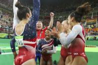 Simone Biles celebrates with team mates following her floor routine during the women's team final. REUTERS/Mike Blake