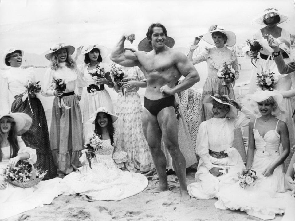 <p>Arnold Schwarzenegger with the women from Folies Bergère at Cannes Film Festival in 1977. </p>