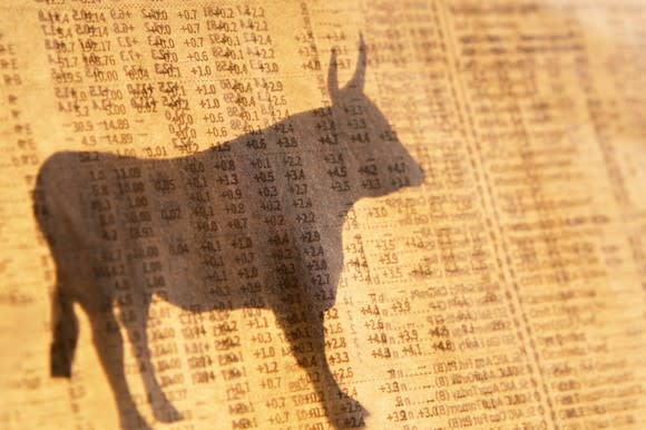 Shadow of a stock market bull over a background of stock prices