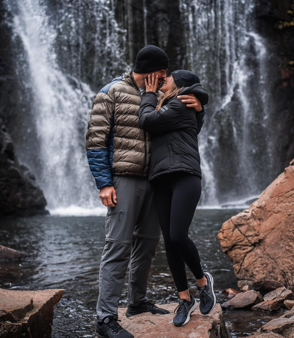 The Bachelor’s Locky Gilbert and Irena Srbinovska kissing in front of a waterfall.