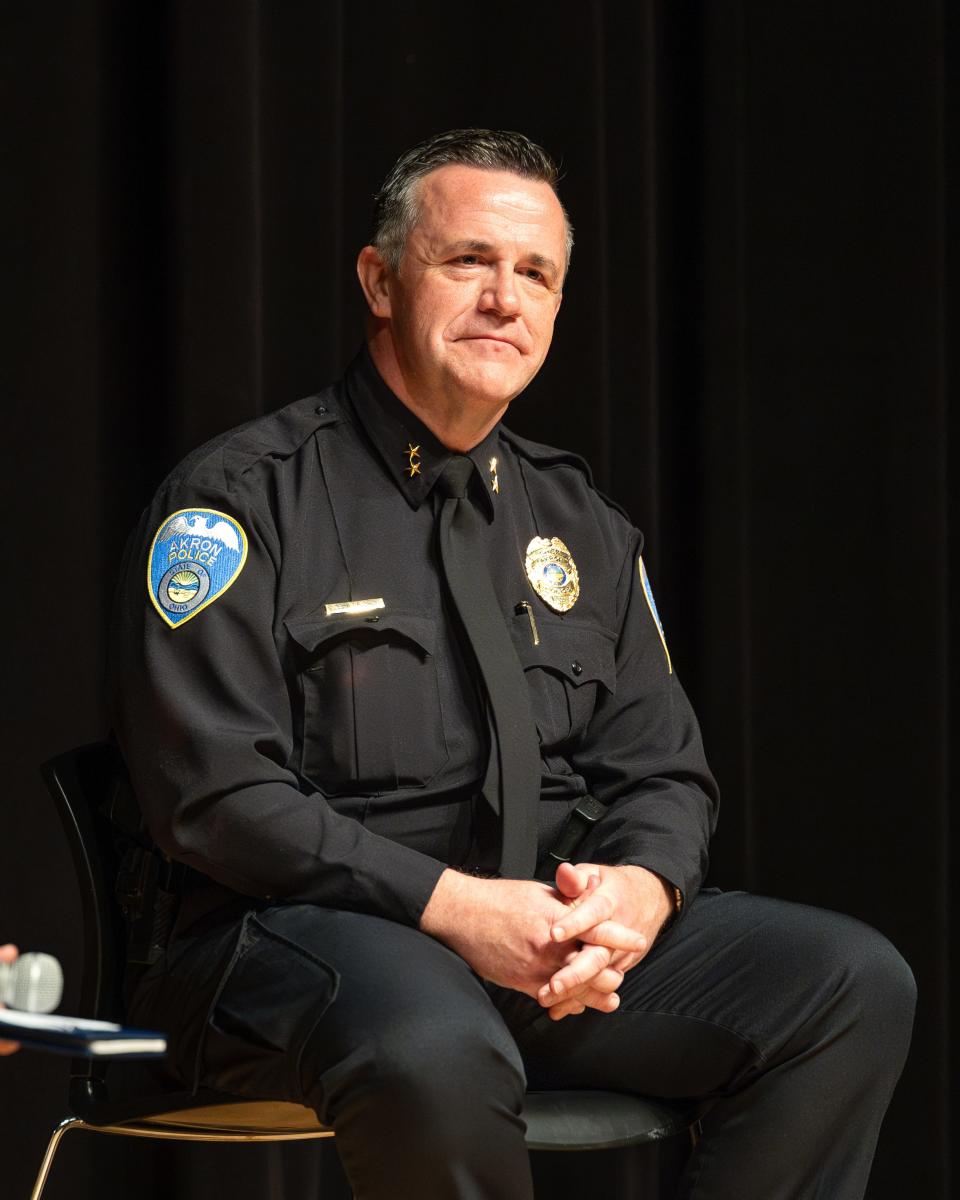 Akron Deputy Police Chief Brian Harding sits to answer community members' questions Saturday during a town hall forum at Buchtel CLC.