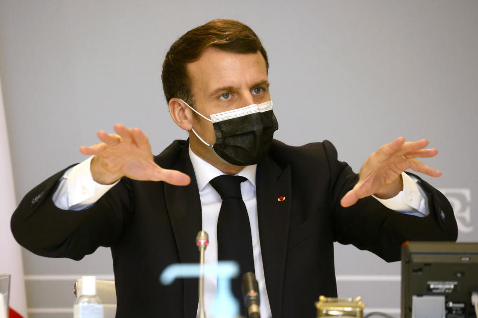 French President Emmanuel Macron gestures during a national cybersecurity strategy meeting at the Elysee Palace in Paris, Thursday, Feb.18, 2021. French President Emmanuel Macron on Thursday unveiled a plan to better arm public facilities and private companies against cybercriminals following ransomware attacks at two hospitals this month and an upsurge of similar cyber assaults in France. (Ludovic Marin, Pool via AP)