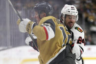 Chicago Blackhawks defenseman Jaycob Megna (24) checks Vegas Golden Knights left wing Pavel Dorofeyev (16) during the first period of an NHL hockey game Tuesday, April 16, 2024, in Las Vegas. (AP Photo/Ian Maule)