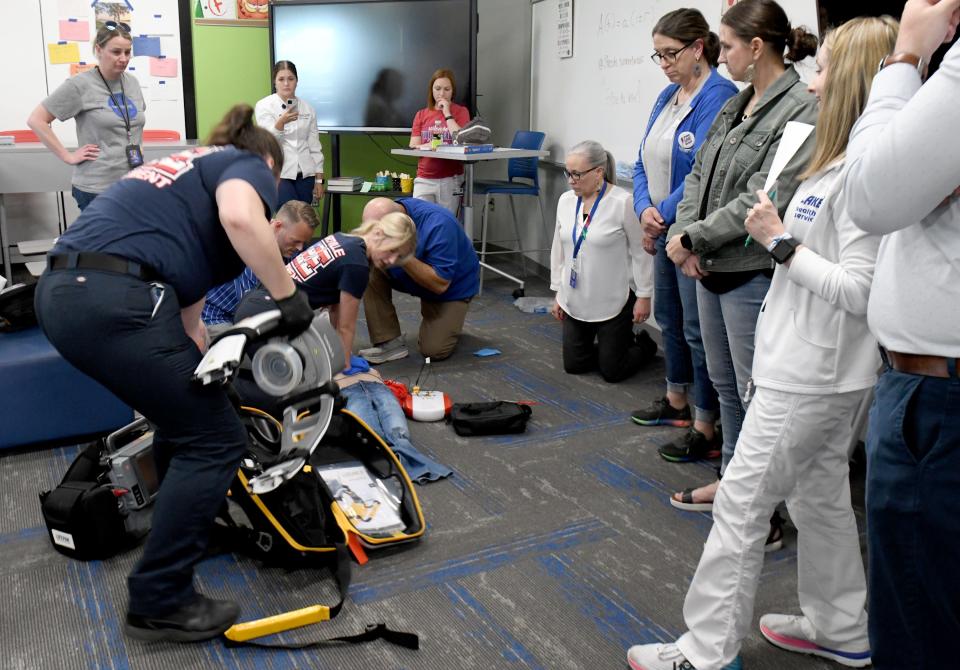 Paramedics with the Hartville Fire Department respond during a sudden cardiac arrest drill at Lake Middle/High School. The Lake Local School District is seeking to become the first Stark County school district to have all of its schools designated as heart safe schools through Project ADAM.