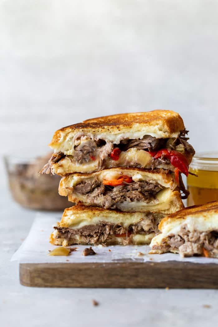 italian beef grilled cheese stacked on wooden board