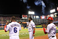 ARLINGTON, TX - OCTOBER 24: (L-R) Esteban German #6, Elvis Andrus #1 and manager Ron Washington celebrate after a solo home run by Adrian Beltre #29 in the sixth inning during Game Five of the MLB World Series against the St. Louis Cardinals at Rangers Ballpark in Arlington on October 24, 2011 in Arlington, Texas. (Photo by Rob Carr/Getty Images)