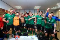 <p>Lincoln City celebrate their win in the changing room after The Emirates FA Cup Fifth Round match between Burnley and Lincoln City at Turf Moor. </p>