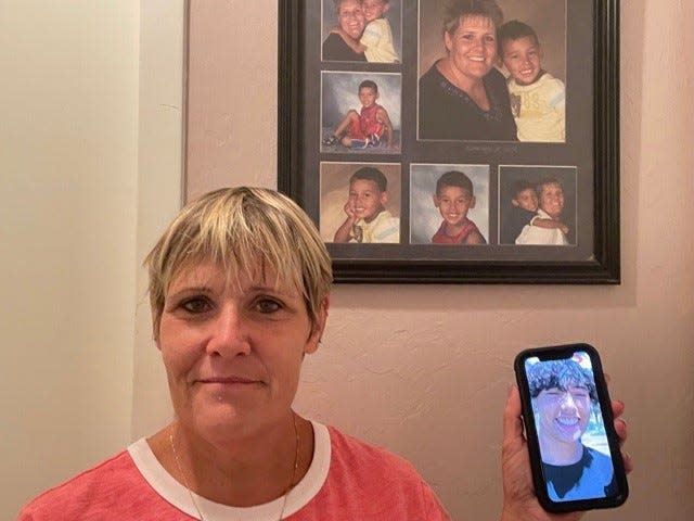 Kris Rodeman of San Carlos Park stands in front of childhood photos of her son and a photo on her cell phone of him now.  Her son was tased by an FHP officer not far from his home June 16 and remains in the Southwest Florida Juvenile Justice Center. His mom plans on proceeding with a lawsuit against the FHP trooper who tased her son.