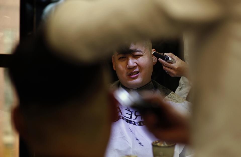 Howard undergoes a haircut before turning into a Kim Jong-un lookalike at a hair salon in Hong Kong