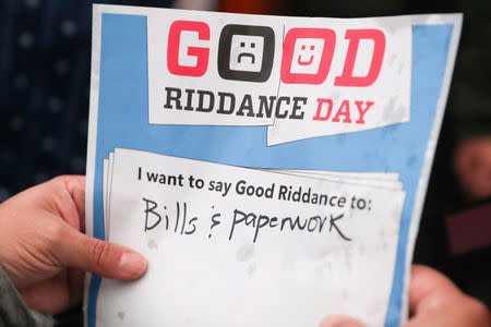 A person holds a message with a bad memory during the National Good Riddance day ceremonial shredding of bad memories of 2018 in Times Square in the Manhattan borough of New York, U.S., December 28, 2018. REUTERS/Jeenah Moon