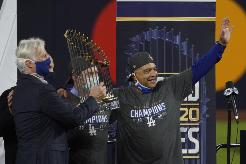 Los Angeles Dodgers manage Dave Roberts celebrates with the trophy after defeating the Tampa Bay Rays 3-1 to win the baseball World Series in Game 6 Tuesday, Oct. 27, 2020, in Arlington, Texas. (AP Photo/Tony Gutierrez)