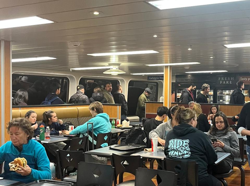 people lining up at the cafeteria on a ferry in canada