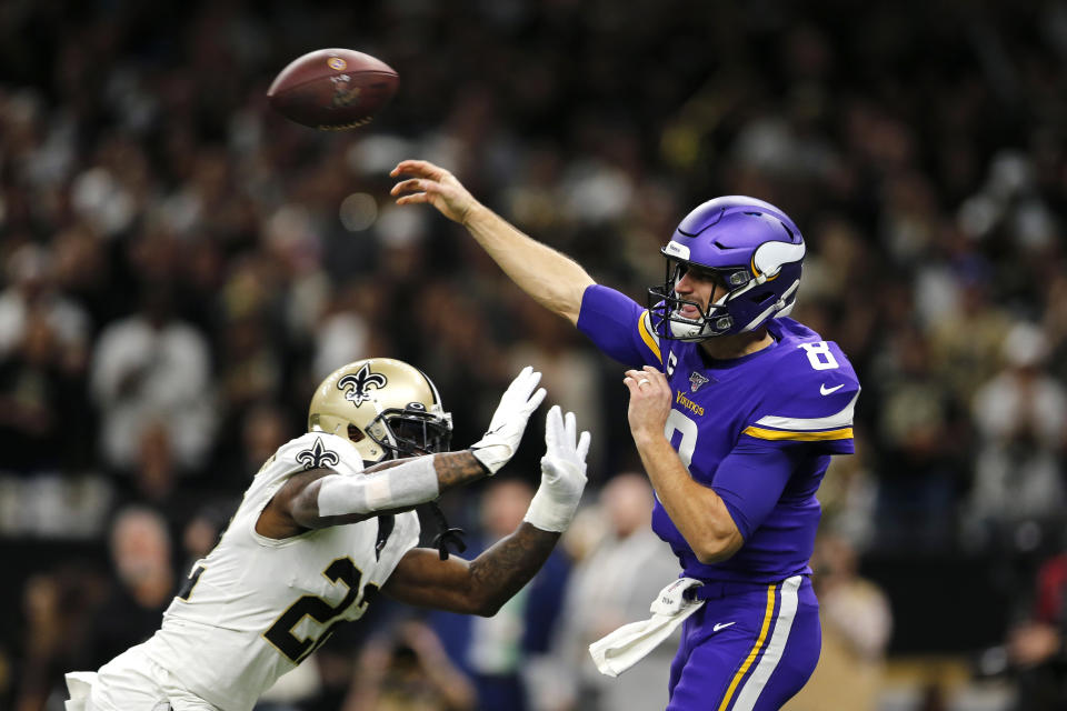 Minnesota Vikings quarterback Kirk Cousins (8) passes under pressure from New Orleans Saints defensive back Chauncey Gardner-Johnson (22) in the first half of an NFL wild-card playoff football game, Sunday, Jan. 5, 2020, in New Orleans. (AP Photo/Brett Duke)