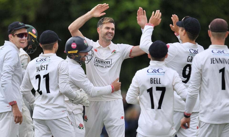 <span>Jimmy Anderson is congratulated by Lancashire teammates after taking his fifth wicket – two more were to follow.</span><span>Photograph: Lancashire Cricket</span>