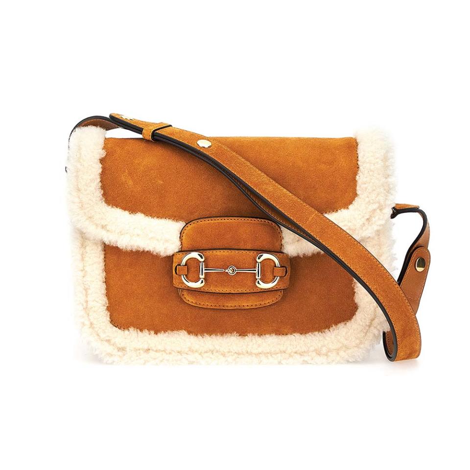 Standouts from Gucci’s Après-Ski collection include cozy shearling accessories such as this Horsebit 1955 suede and shearling bag; $3,790, gucci.com