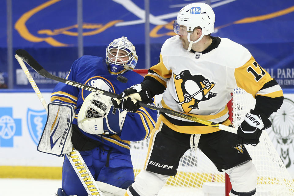Buffalo Sabres goalie Dustin Tokarski (31) stops a tipped shot by Pittsburgh Penguins forward Bryan Rust (17) during the second period of an NHL hockey game, Sunday, April 18, 2021, in Buffalo, N.Y. (AP Photo/Jeffrey T. Barnes)