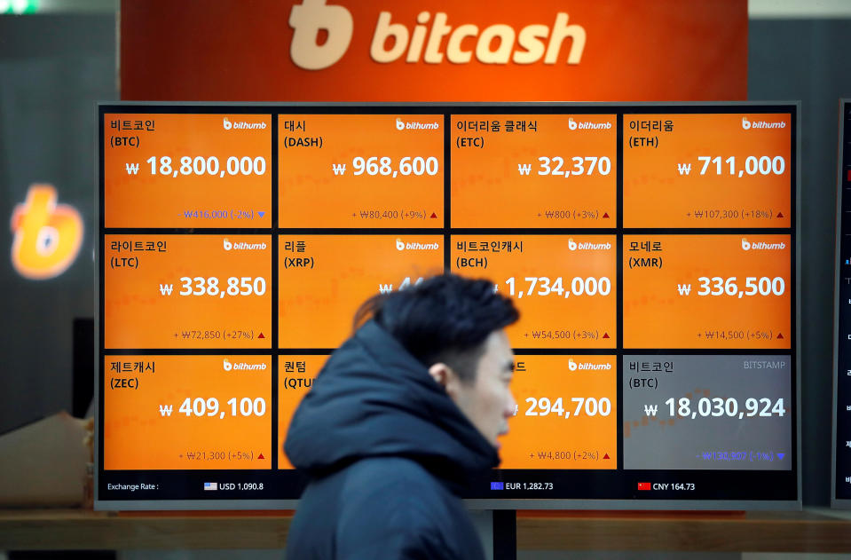 A man walks past an electric board showing exchange at a cryptocurrencies exchange in Seoul, South Korea (REUTERS/Kim Hong-Ji)