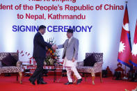 Chinese President Xi Jinping, left, and Nepalese Prime Minister Khadga Prasad Oli shake hands during their bilateral meeting in Kathmandu, Nepal, Sunday, Oct. 13, 2019. Xi on Saturday became the first Chinese president in more than two decades to visit Nepal, where he's expected to sign agreements on some infrastructure projects. (Bikash Dware/The Rising Nepal via AP)