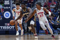 New Orleans Pelicans forward Zion Williamson (1) scoops in a loose ball against Detroit Pistons guard Jaden Ivey (23) in the first half of an NBA basketball game in New Orleans, Wednesday, Dec. 7, 2022. (AP Photo/Gerald Herbert)