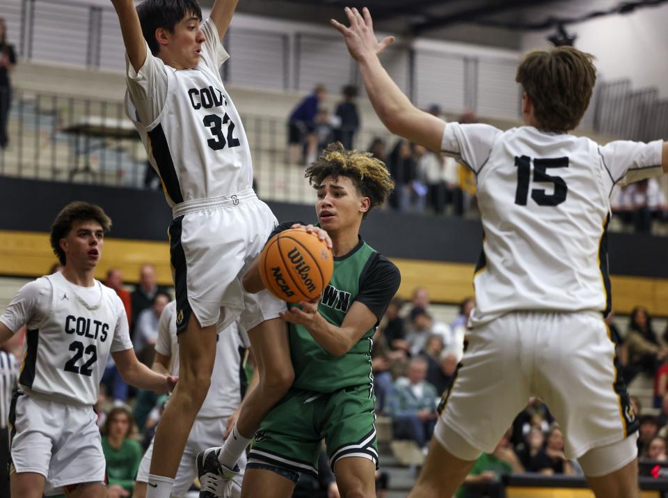 Hillcrest’s Damani Wilkerson is surrounded by Cottonwood High’s defense at Cottonwood High in Murray on Wednesday, Feb. 7, 2024. | Laura Seitz, Deseret News