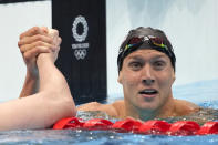 Caeleb Dressel of the United States celebrates winning the men's 100-meter freestyle final at the 2020 Summer Olympics, Thursday, July 29, 2021, in Tokyo, Japan. (AP Photo/Matthias Schrader)