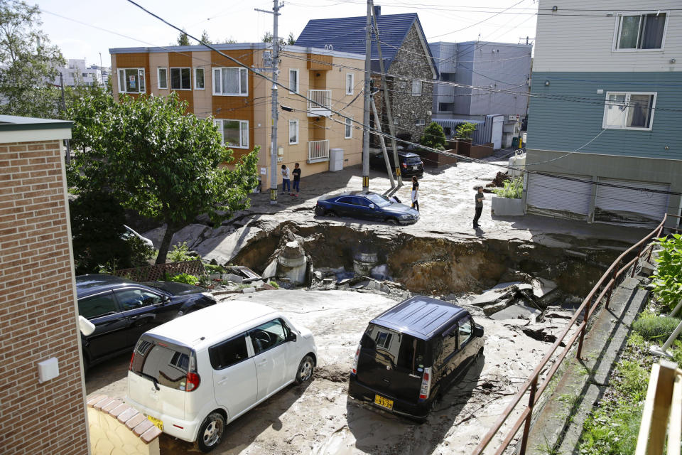 <p>Cars sit on a road damaged by an earthquake in Sapporo, Hokkaido, northern Japan, Thursday, Sept. 6, 2018. (Photo: Hiroki Yamauchi/Kyodo News via AP) </p>