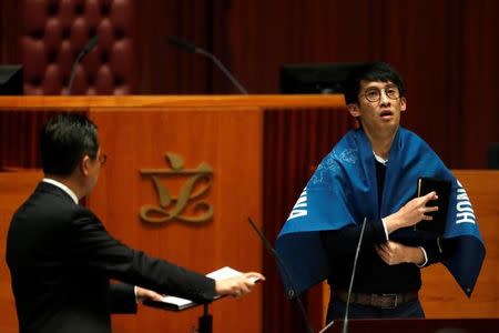 Newly elected lawmaker Baggio Leung wears a banner "Hong Kong is not China" while taking oath at the Legislative Council. REUTERS/Bobby Yip