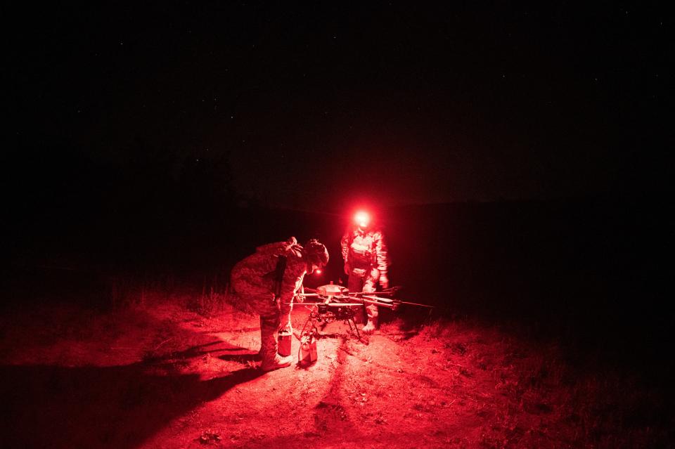 Servicemen of the "Achilles" Battalion from Ukraine's 92nd assault brigade check a Vampire hexacopter drone after mission flight near Chasiv Yar, in the Donetsk region, on May 1, 2024.