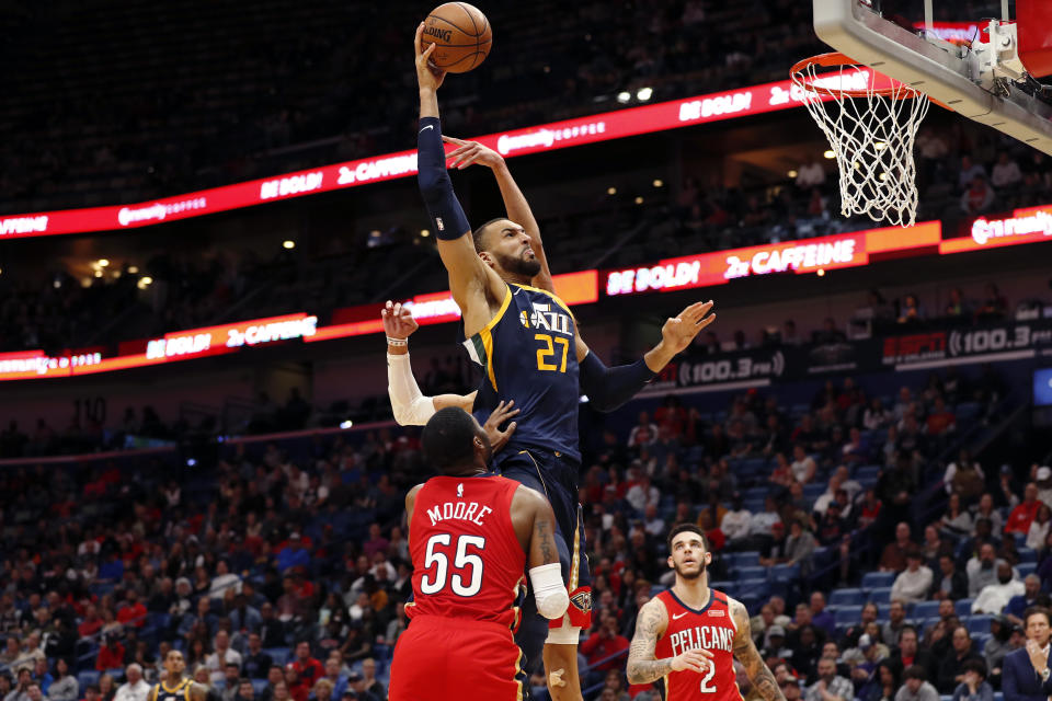 Utah Jazz center Rudy Gobert (27) drives to the basket in front of New Orleans Pelicans guard E'Twaun Moore (55) in the second half of an NBA basketball game in New Orleans, Monday, Jan. 6, 2020. (AP Photo/Tyler Kaufman)