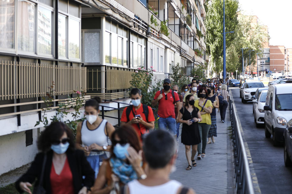 Teachers and administrative staff wait near the Mar&iacute;a Zambrano Secondary School for coronavirus tests on Sept. 3 in Madrid. There have been reports of people having to wait for days to more than a week for results. (Photo: Europa Press News via Getty Images)