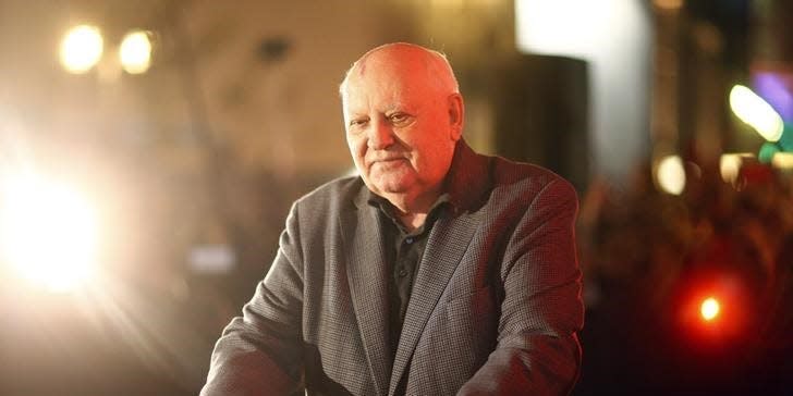 Former Soviet President Mikhail Gorbachev^makes an impression with his hands in cement as he visits the former Berlin Wall border crossing point Checkpoint Charlie, in Berlin November 7, 2014. REUTERS/Hannibal Hanschke