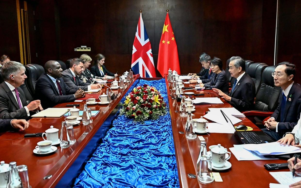 China's Foreign Minister Wang Yi (2nd R) and Britain's Foreign Secretary David Lammy (2nd L) take part in a ministerial meeting on the sidelines of the 57th Association of Southeast Asian Nations