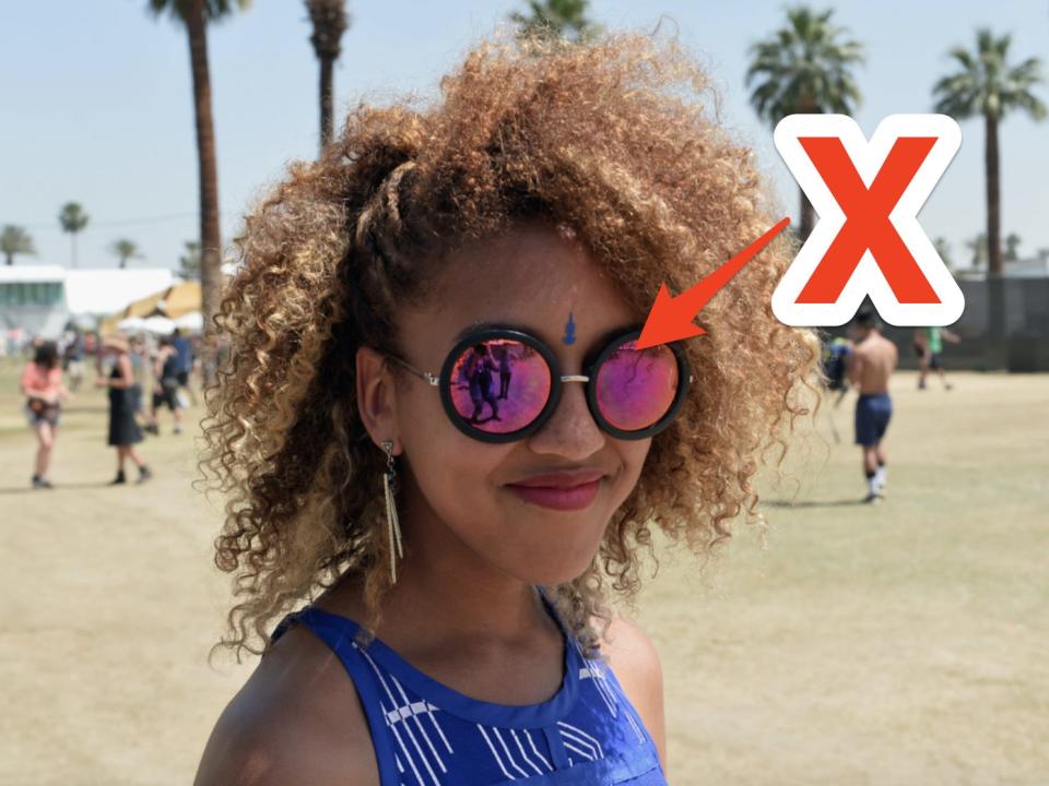 red x and arrow pointing to a pair of big oversized round sunglasses a woman is wearing at coachella