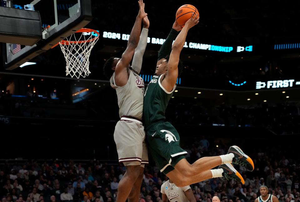 Michigan State's Jaden Akins (3) goes up for a shot against Mississippi State's Josh Hubbard (13) during their first-round game in the NCAA Tournament at the Spectrum Center in Charlotte on March 21, 2024.