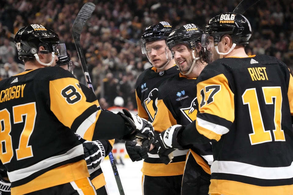 Pittsburgh Penguins' Kris Letang, second from right, celebrates with Bryan Rust (17), John Ludwig, third from right, and Sidney Crosby (87) after scoring during the second period of an NHL hockey game against the Philadelphia Flyers in Pittsburgh, Saturday, Dec. 2, 2023. (AP Photo/Gene J. Puskar)