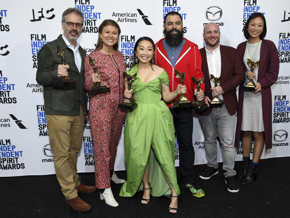From left, Peter Saraf, Daniele Melia, Lulu Wang, Andrew Miano, Eddie Rubin, Anita Gou pose in the press room with the award for best feature for "The Farewell" at the 35th Film Independent Spirit Awards on Saturday, Feb. 8, 2020, in Santa Monica, Calif. Lulu Wang, center, also poses with the award for best supporting female for "The Farewell," which she accepted on behalf of Zhao Shuzhen. (Photo by Richard Shotwell/Invision/AP)