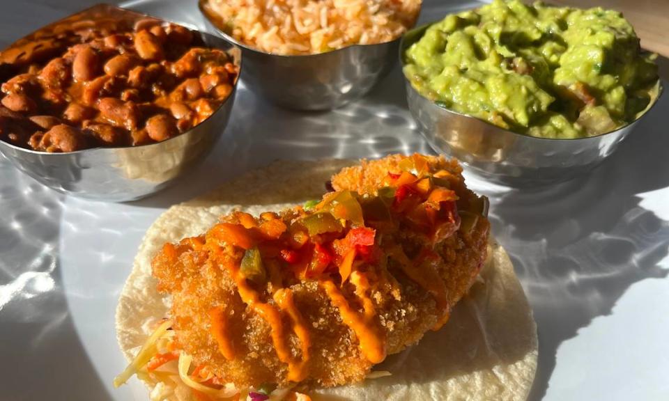 Picasso Taqueria’s fried chicken taco with rice, beans and guacamole.