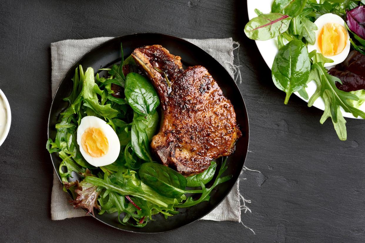 salad with egg next to steak