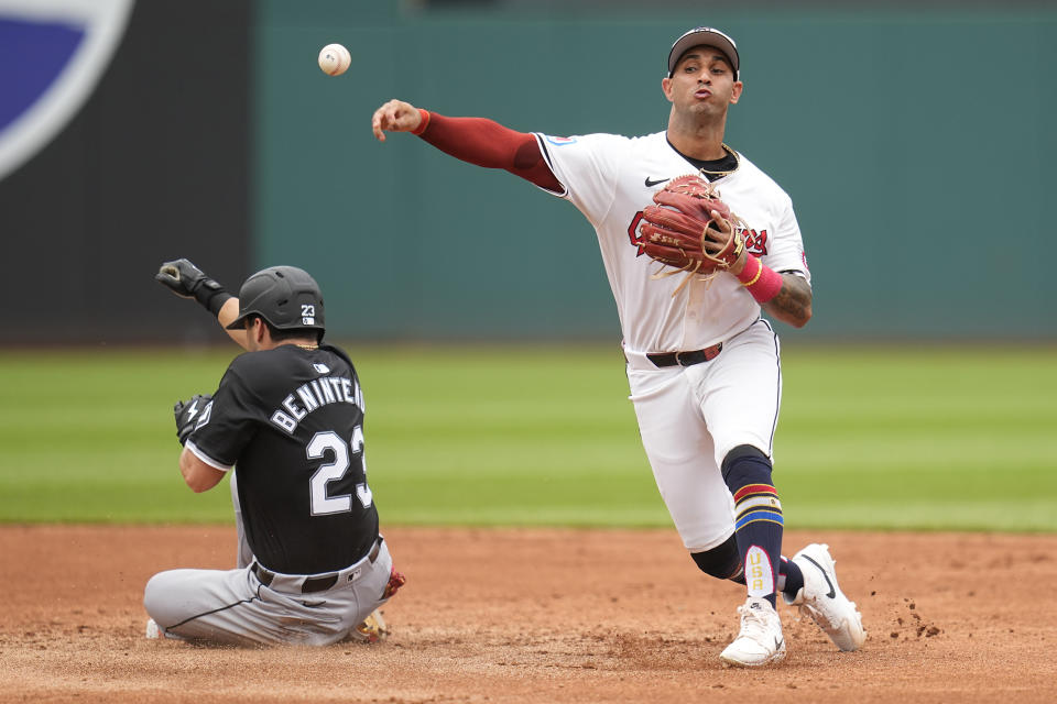 Cleveland Guardians shortstop Brayan Rocchio, right, throws to first base after forcing out Chicago White Sox's Andrew Benintendi (23) in the third inning of a baseball game Thursday, July 4, 2024, in Cleveland. White Sox's Gavin Sheets was safe at first base. (AP Photo/Sue Ogrocki)